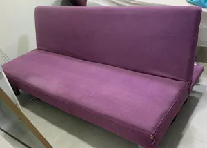 Purple fabric sofa bed / futon in good used condition