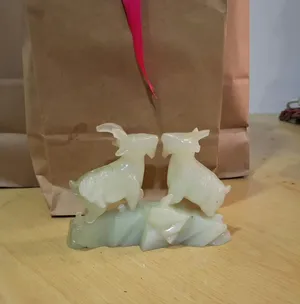 I have a jade stone sculpture featuring two beautifully carved animal figures