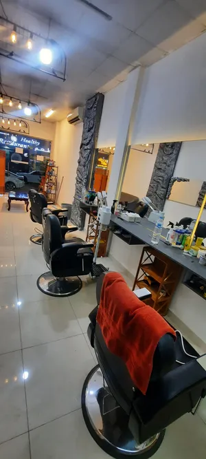 Men's barber shop on Al-Khair Street. Regular customer and 3 chairs ready for activity