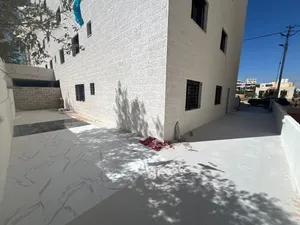 شقة ارضيه 136م مع ترس 128م وكراج خاص طريق المطار خلف جامعة البتراء