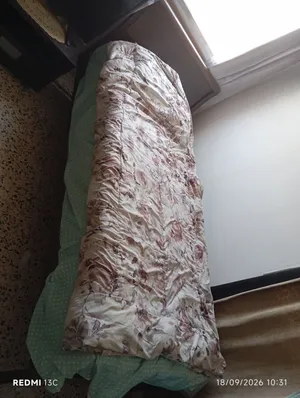 A strong wooden bed for sale with mattress