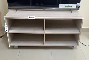 Light wood TV stand / entertainment unit with 4 open shelves and wheels