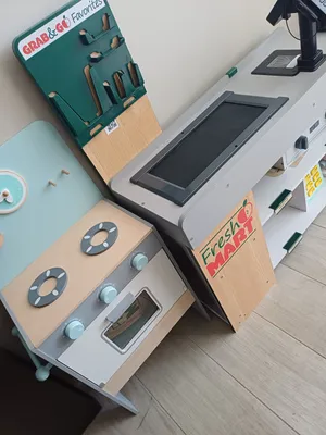 Wooden play kitchen and supermarket checkout