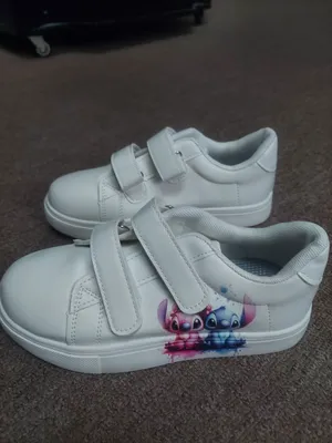 I'm selling brand new sneakers with a picture of Stitch, size 33.