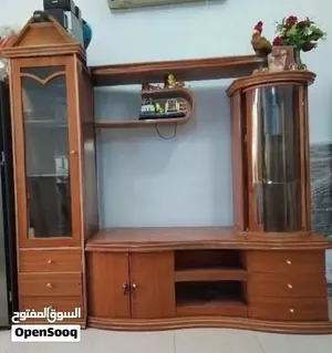 Elegent wooden wall unit with display cabinets and storage.