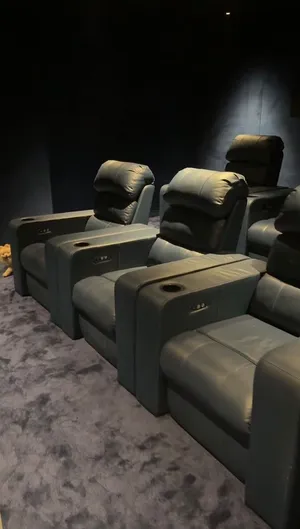 Home Theater Electric Recliner Seats. Cinema-style recliners with cup holders and reclining buttons.