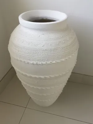 Beautiful clay pot painted in white.