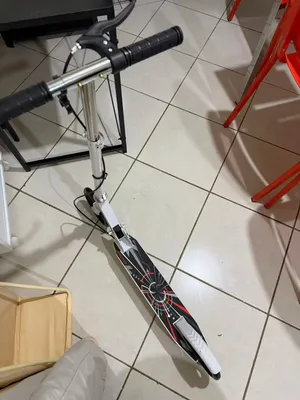 silver scooter bike available for sell, beand new fully functional wheels and handle
