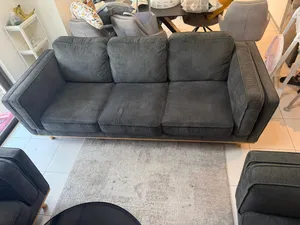 Three-seater grey fabric sofa in good used condition + two one-seater sofa