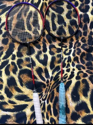 Pair of used Triumph badminton rackets with grips