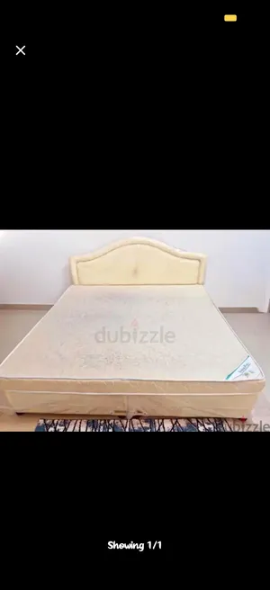King size bed with mattress and upholstered headboard with mattress topper and headboard cover