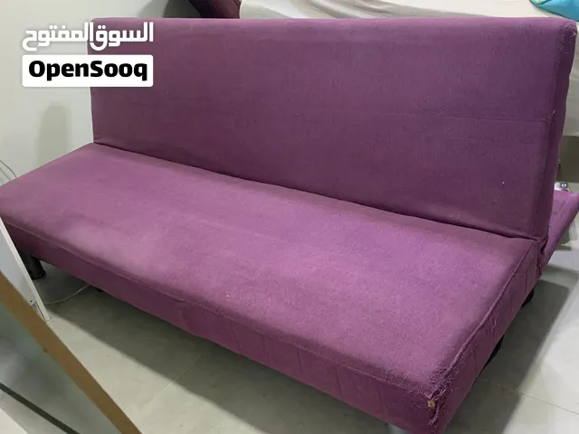 Purple fabric sofa bed / futon in good used condition