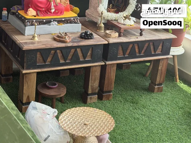 A sturdy wooden coffee table with 2 side tables