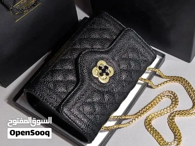 black quilted PU leather cross-body bag featuring a textured caviar-style finish, a distinctive gold