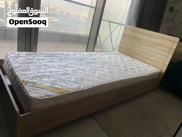 Wooden bed with one free matress with it