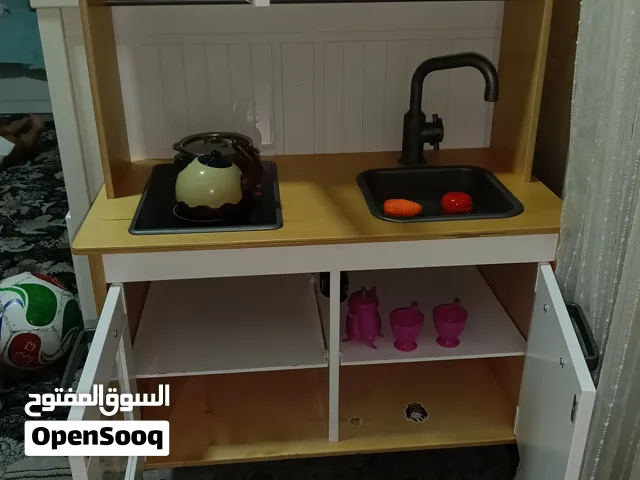 girls wooden IKEA kitchen set with utensils and cutlery