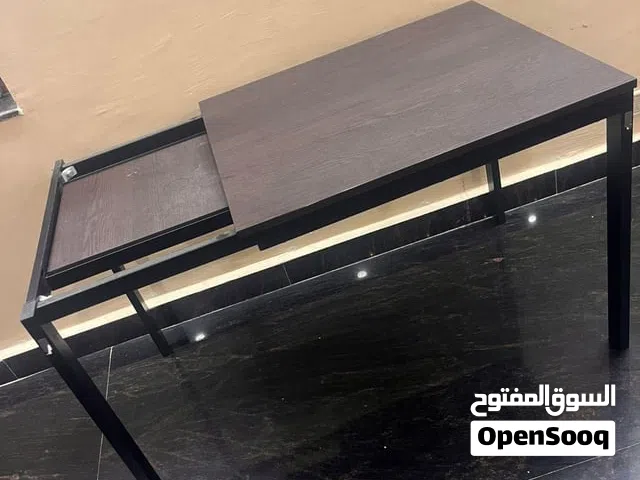 IKEA Vangsta extendable table, featuring a dark brown wood-effect top and a black metal frame.