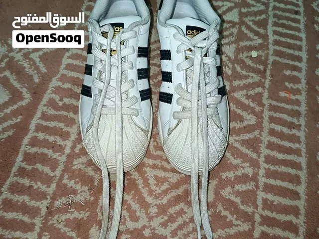 Adidas Superstar sneakers, featuring the iconic black heel tab with the whiteAdidas Superstar sneake