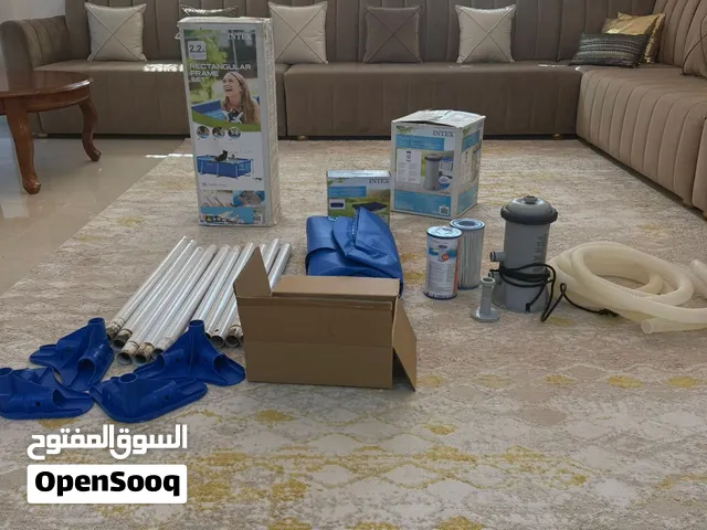 Swimming pool with filter pump, used filter and new filter, and pool cover