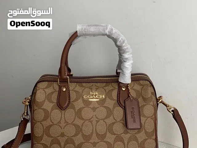 Coach Rowan Satchel in signature coated canvas with brown trim and gold-tone hardware.