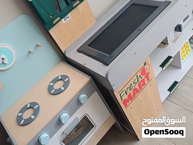 Wooden play kitchen and supermarket checkout