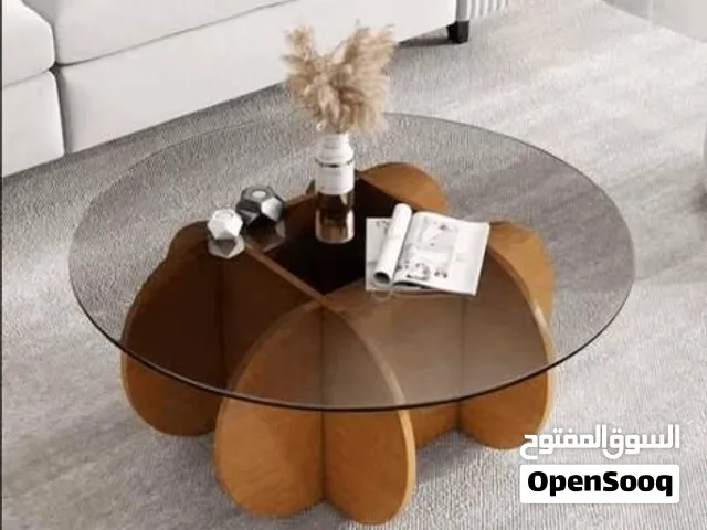 Round glass coffee table, wooden petal base