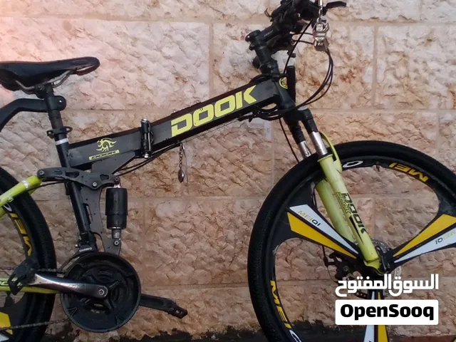 دراجة جبلية رياضية من نوع Dook مقاس 26 تتميز بهيكل ألمنيوم قابل للطي ومساعدات مزدوجة لامتصاص الصدمات