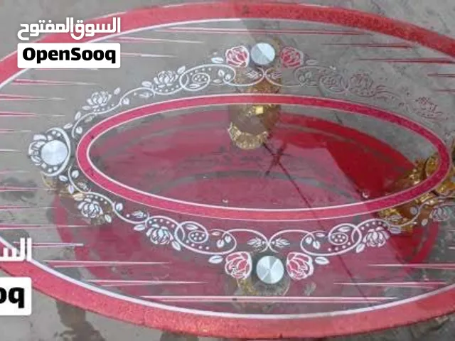 طاولة وسط بيضاوية فخمة، زجاج وقاعدة حمراء نضيفه كلش