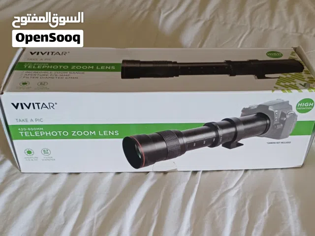 عدسة كاميرا مع مضاعف التقريب جديدتان بالكرتون .