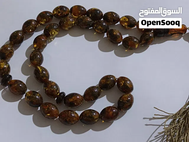 سبحة كهرب حجر لون ذهبي واسود
