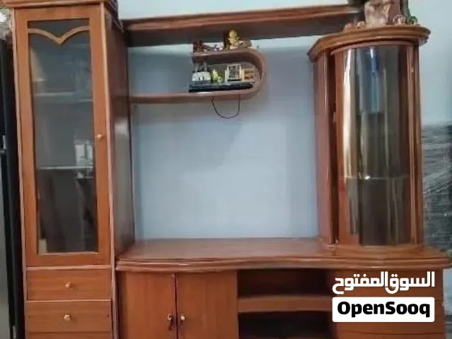 Elegent wooden wall unit with display cabinets and storage.