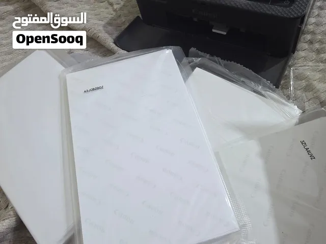 طابعه سلفي كانون 1500 مع كاترج داخل الطابعه وثلاث اكياس ورق خاص بالطابعه