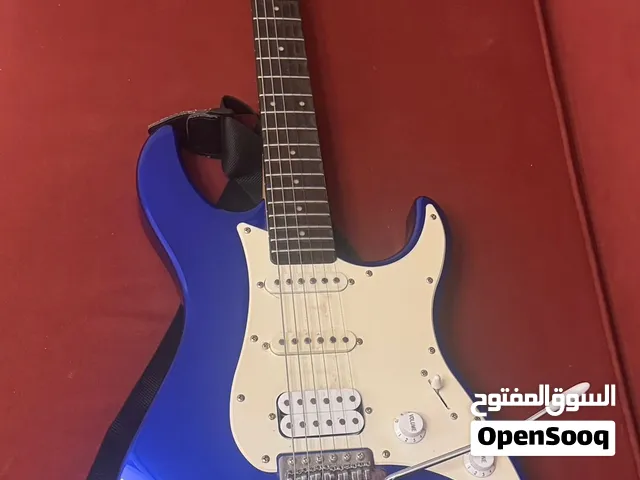 amazing yamaha electric guitar with guitar strings and capo and amplifier wire and guitar bag