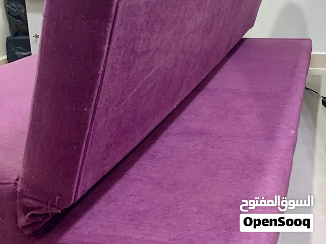 Purple fabric sofa bed / futon in good used condition