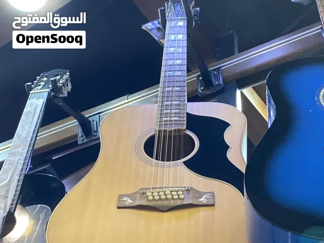 آلات موسيقية ا جيتار ايكو خشب برندن  12وتر فياس 14انش لون واحد بيج مع شنتة وريشة متوفر توصيل