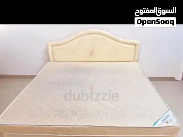 King size bed with mattress and upholstered headboard with mattress topper and headboard cover