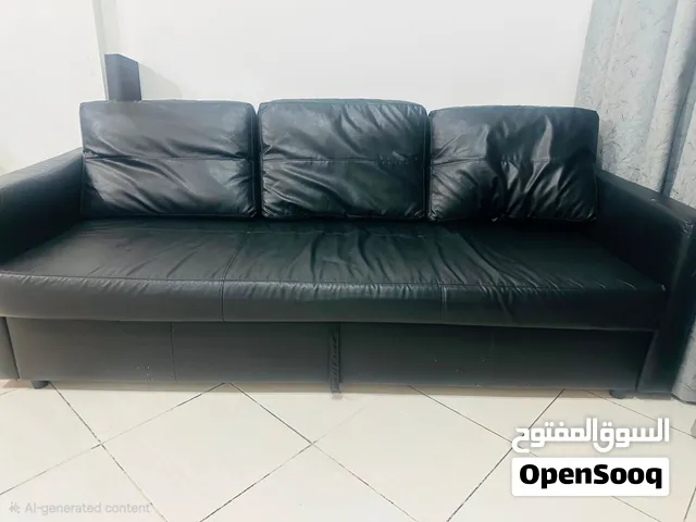 Negotiable- IKEAconvertible sofa bed in black faux leather with storage